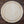 Round wooden cutting board on a rustic wooden surface