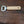 Bottle opener with wooden handle on a wooden surface